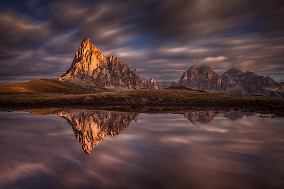 Moving clouds over the calm lake